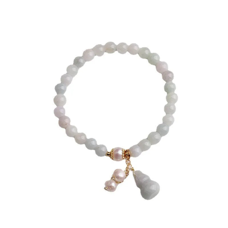 Emerald green jade bracelet with Chinese gourd design elements