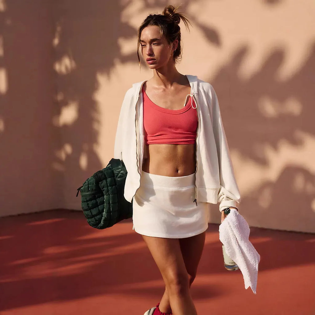 Women's blue hooded zip-up jacket and matching miniskirt streetwear outfit set on a hanger