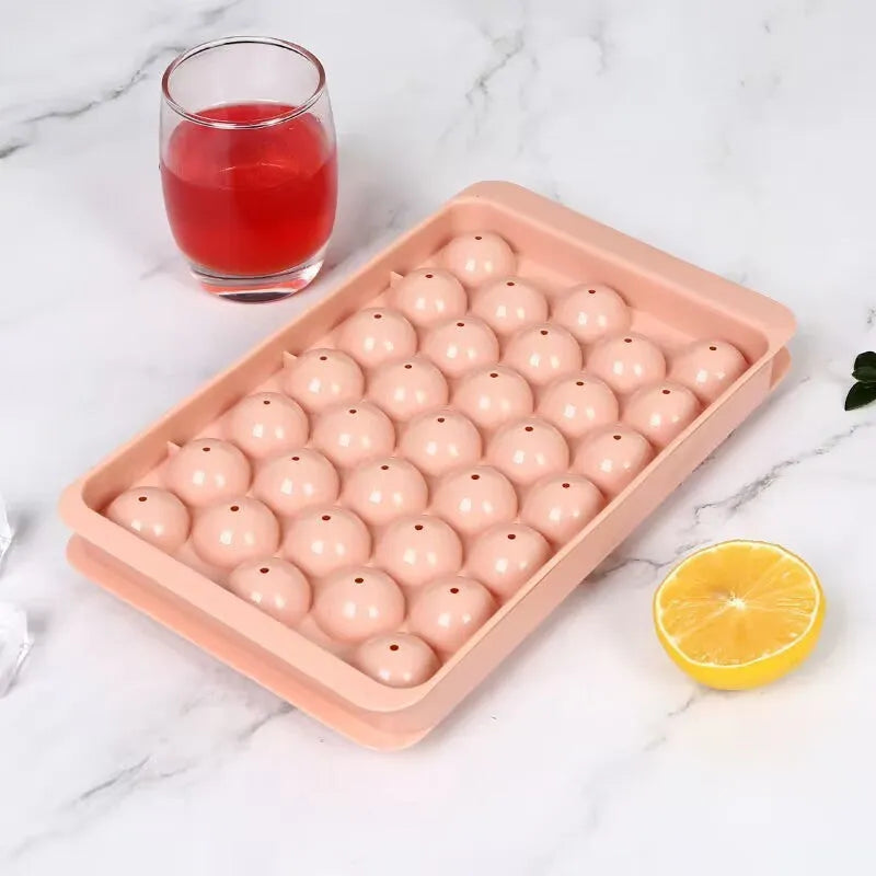 Blue silicone ice cube tray with lid showing 33 round moulds for homemade ice making