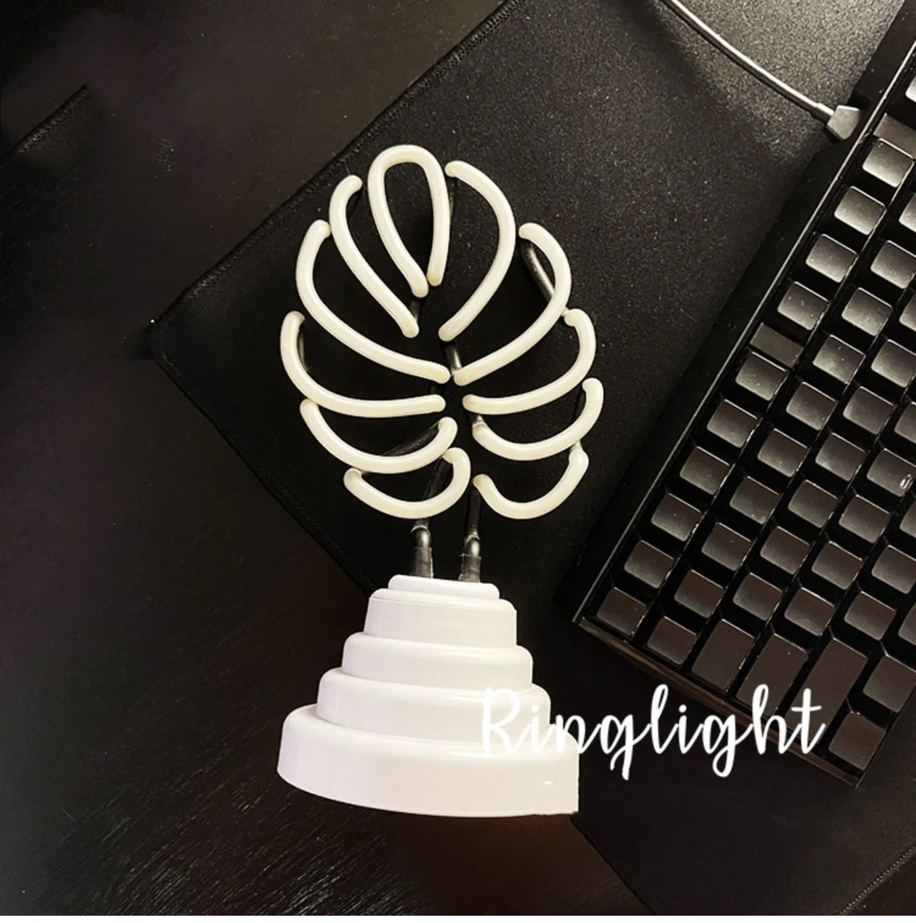 White tube bamboo shape desktop lamp emitting green light with USB cable