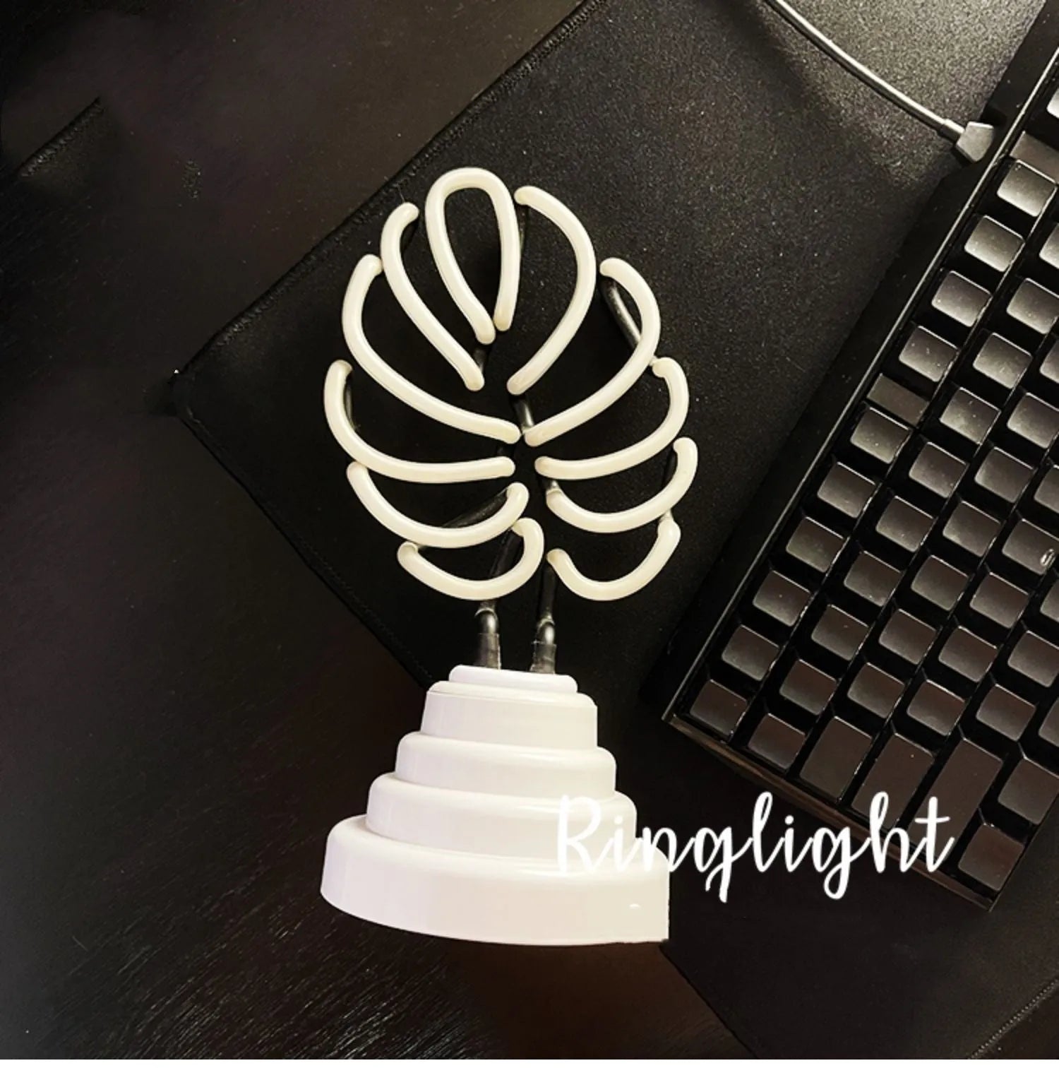 White tube bamboo shape desktop lamp emitting green light with USB cable