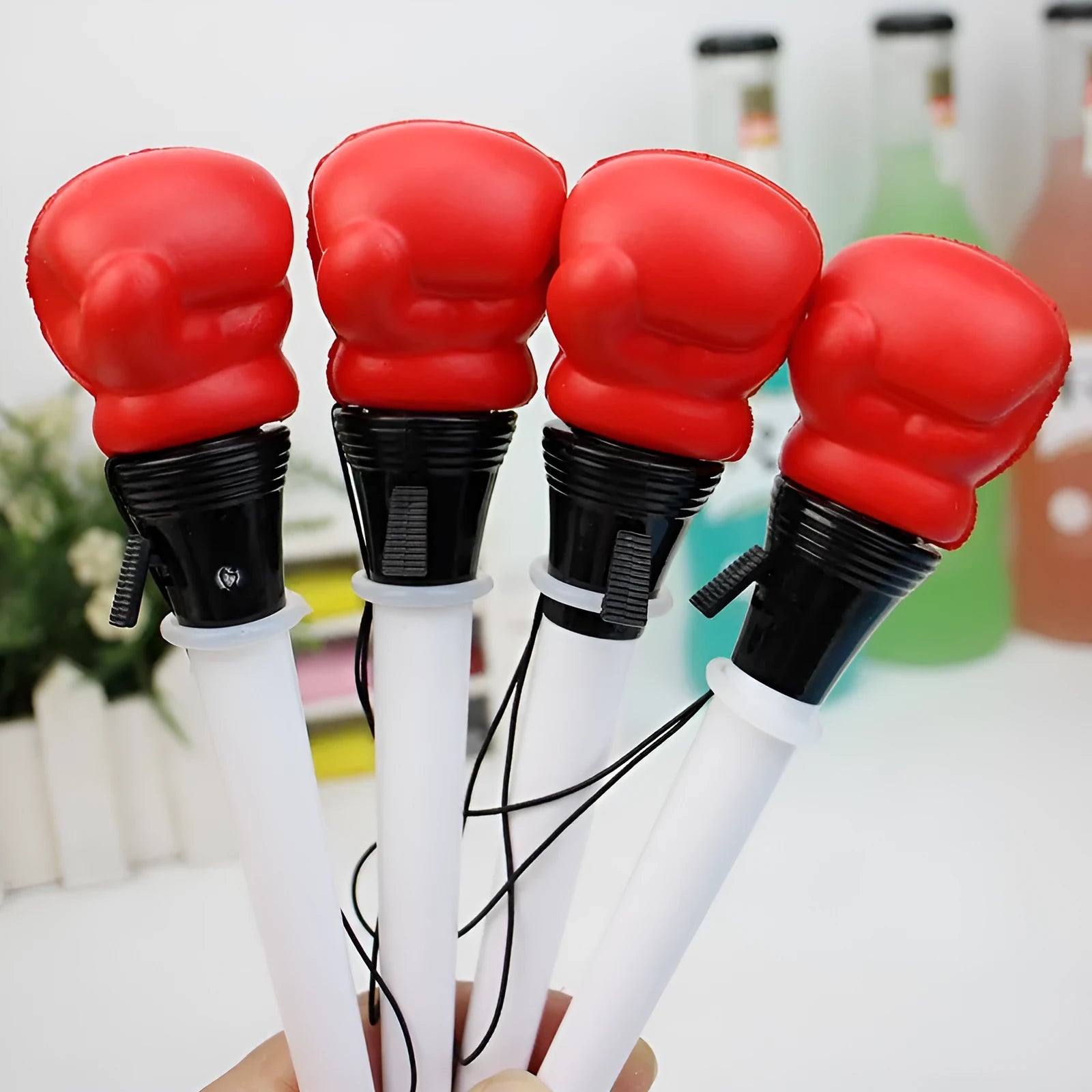 Set of four black and silver boxing press ejection pens with 0.7mm bullet tips displayed on a white surface.