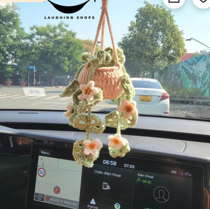 Knitted green and white car plant decoration with hanging rope