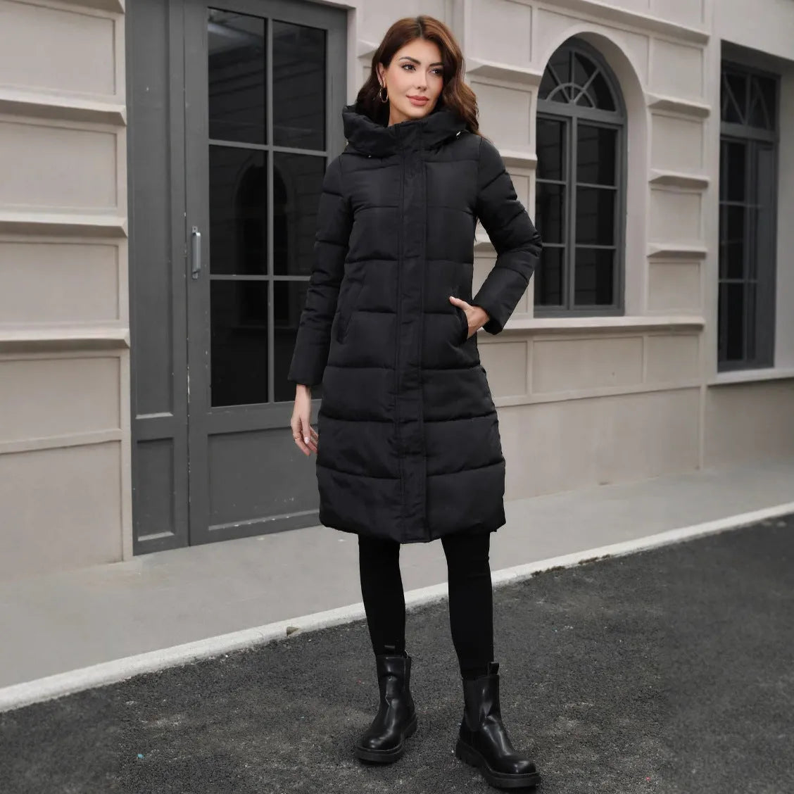 Black hooded long cotton jacket for men with a slim fit design on a model.