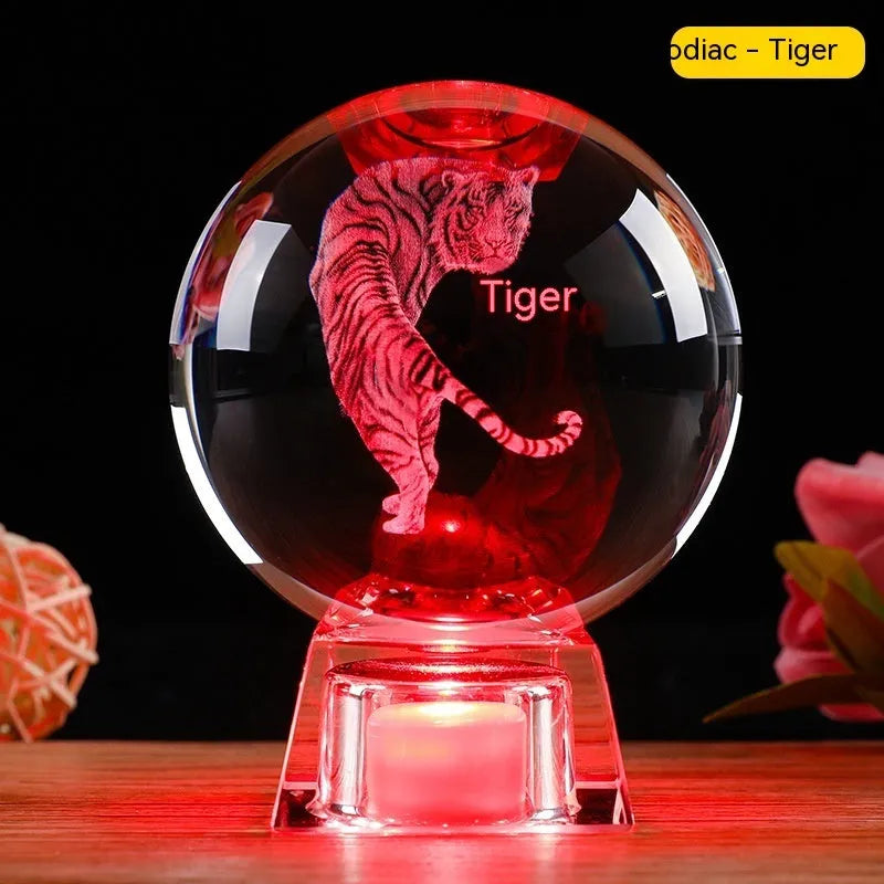 White luminous crystal ball ornament with Chinese zodiac animal figure on electronic base.
