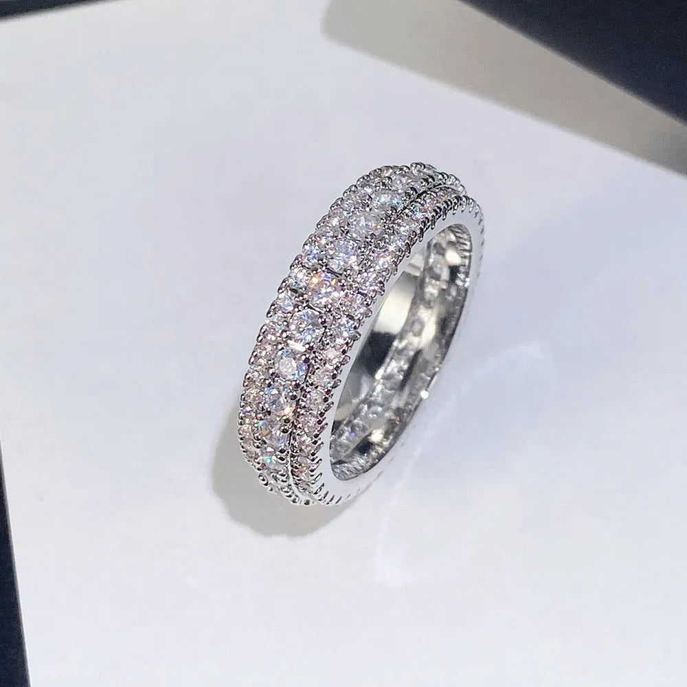Geometric copper engagement ring with triangular zircon stone inlay, shown in a choice of finishes.