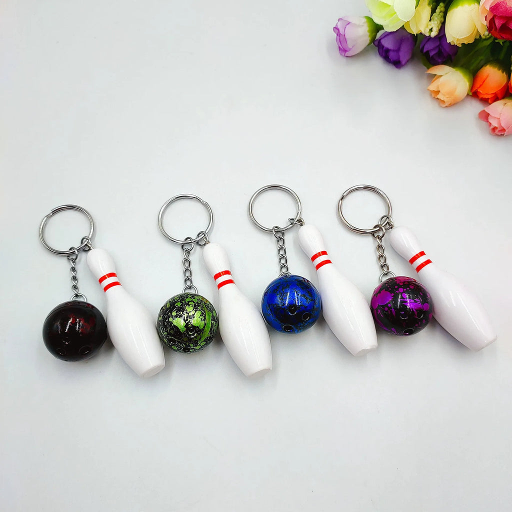 Mini bowling simulation keychain pendant in PVC metal showing four colour options