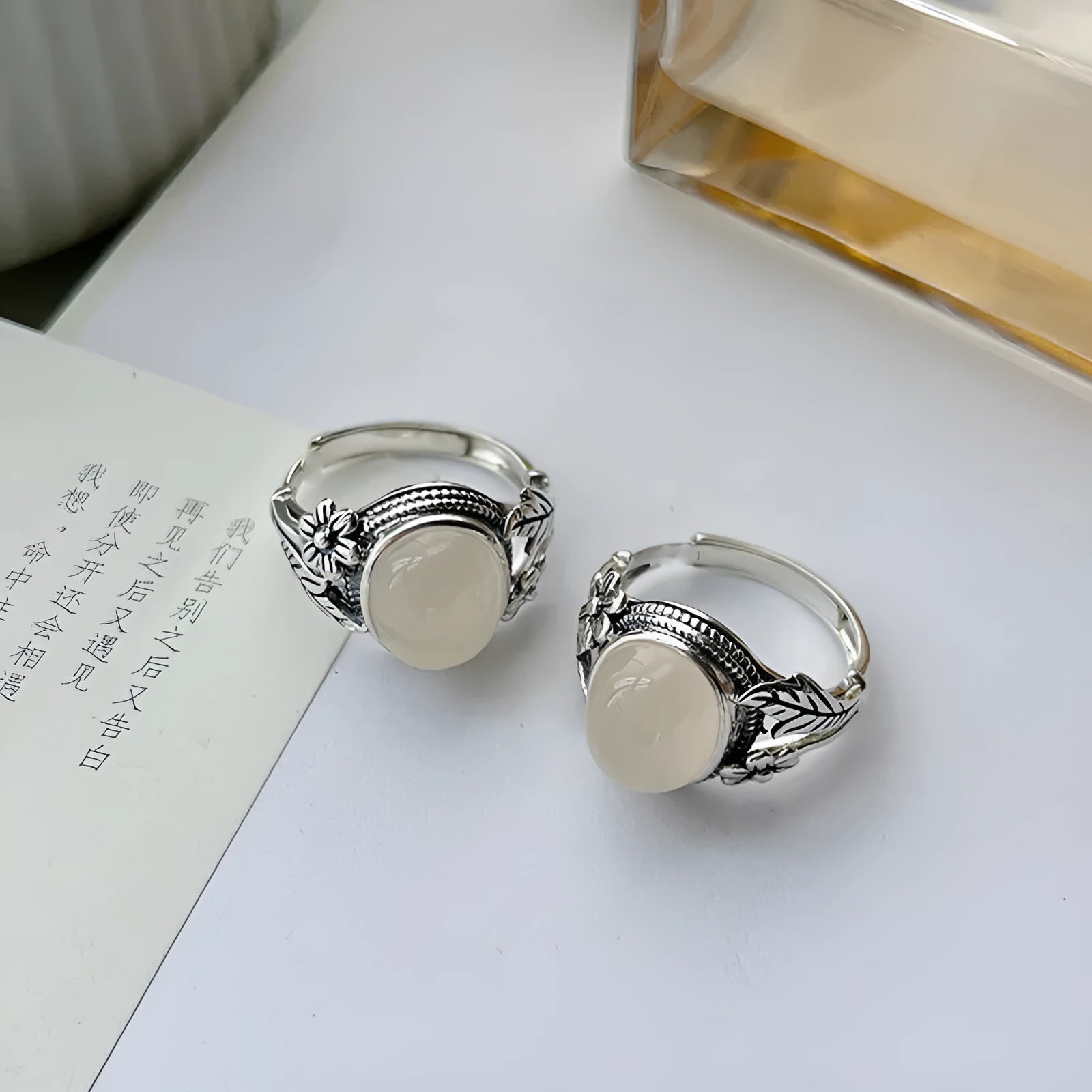 Adjustable copper U-shaped vintage ring with a white chalcedony effect finish.