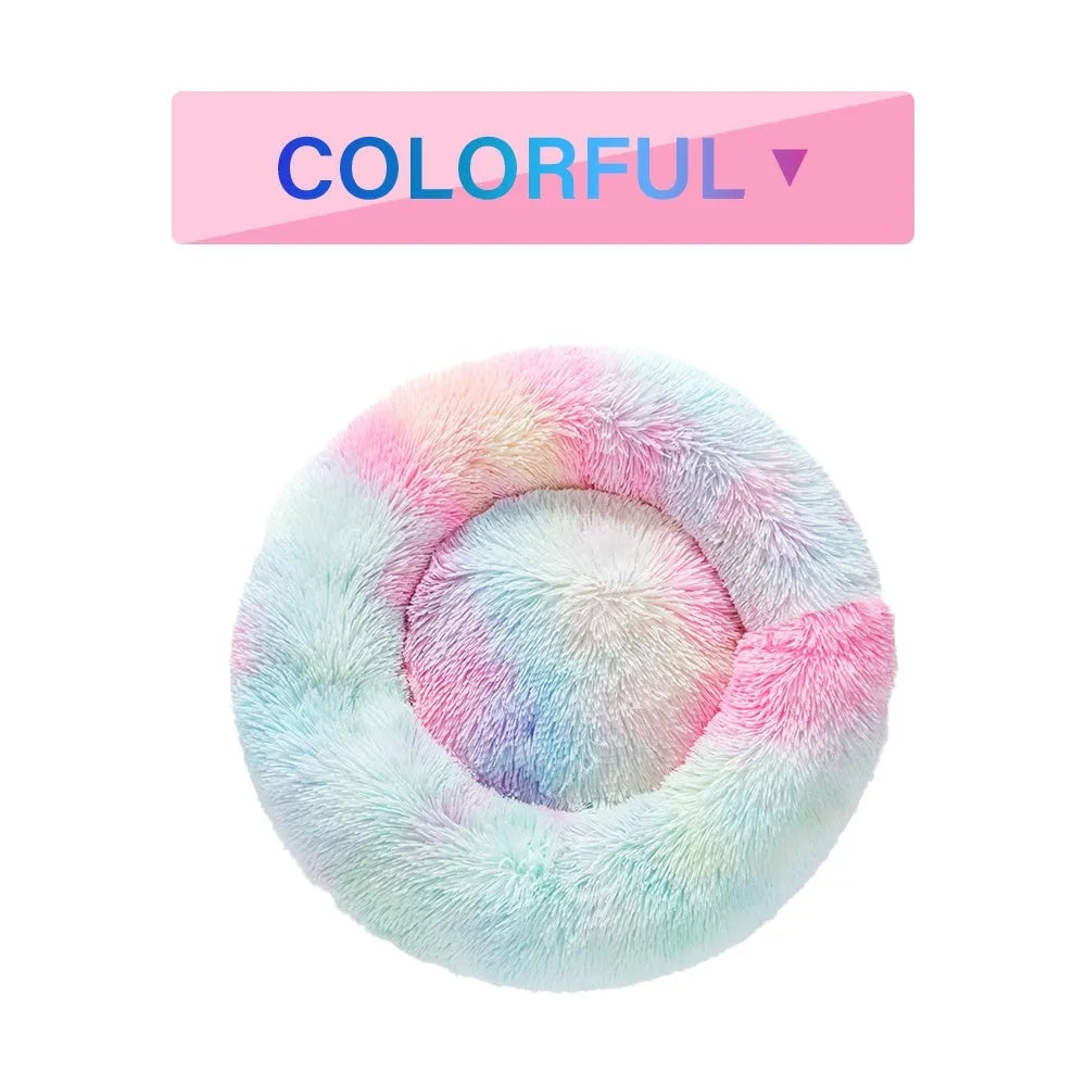 Fluffy grey donut dog bed with raised rim, shown with a small dog sleeping inside.