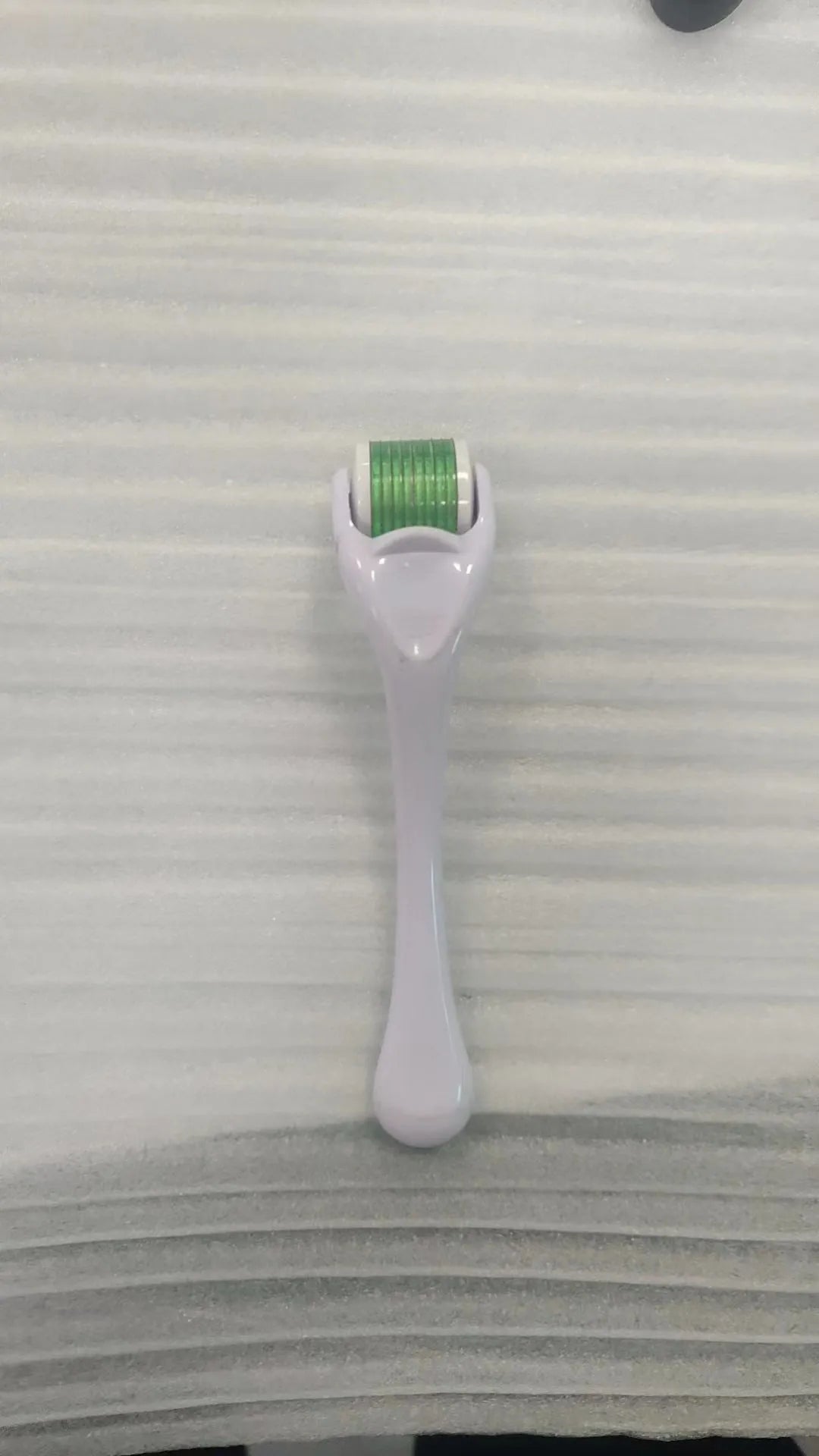 Professional 540 needle dermaroller for mechanical font with coloured handle and wheel, showing sterile stainless steel needles.