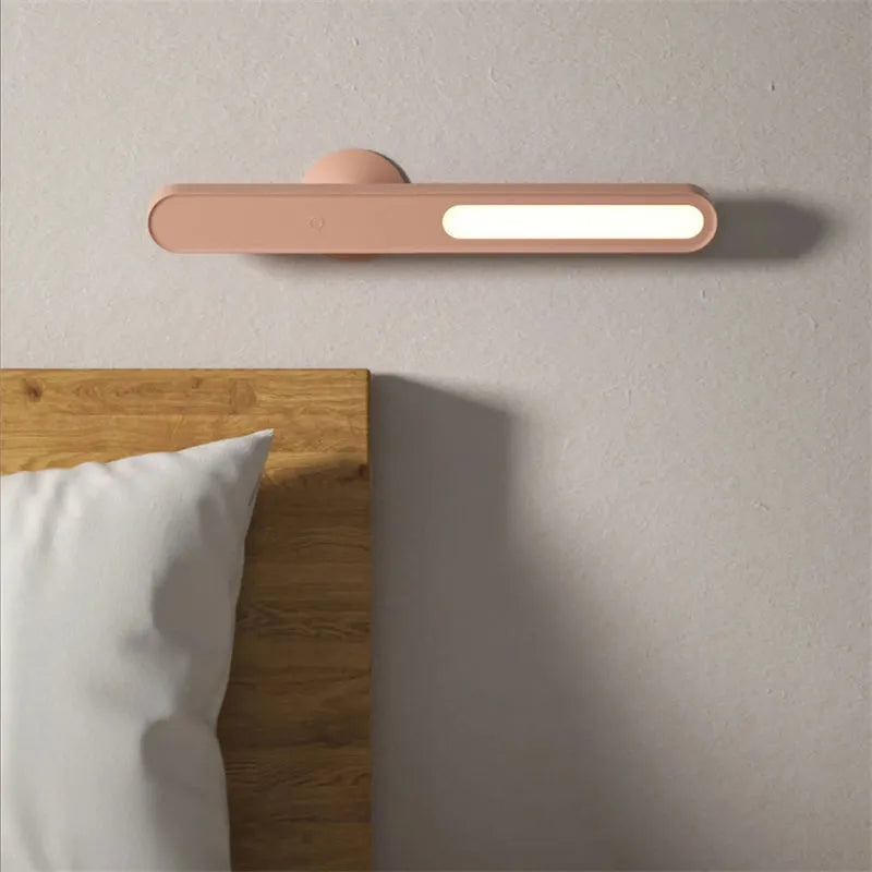 White geometric desk lamp with USB cable and magnetic base for wall mounting.