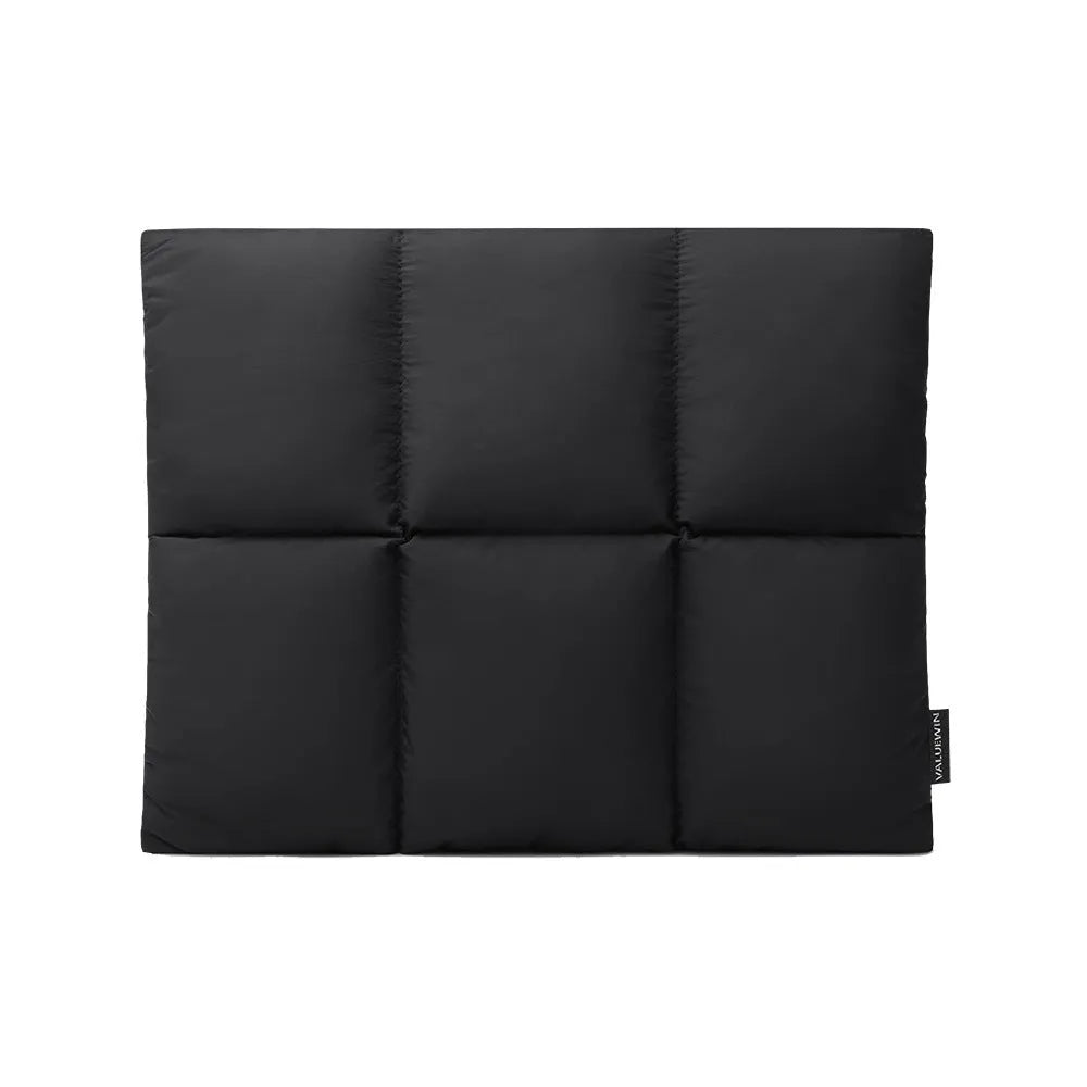 Soft black polyester laptop sleeve for a 15.6-inch laptop on a table.