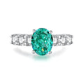 S925 sterling silver emerald ring with inlaid high carbon diamonds in a geometric Palaibahao design on a model's finger.