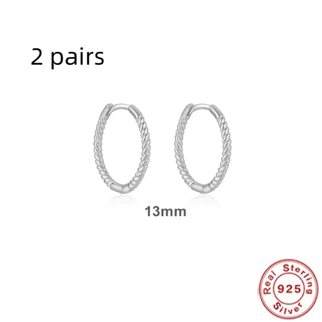 Twisted sterling silver round ring earrings in gold and white gold finishes showing multiple sizes