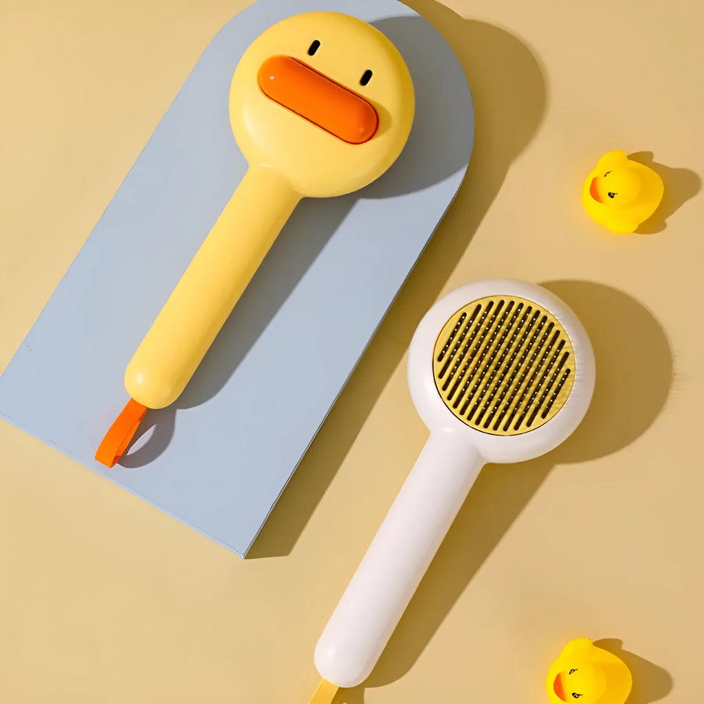 Small yellow duck-shaped pet comb with needle teeth for cat and dog grooming