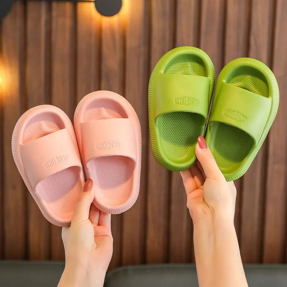 Colourful children's EVA slippers with a thick, textured non-slip sole in various sizes.