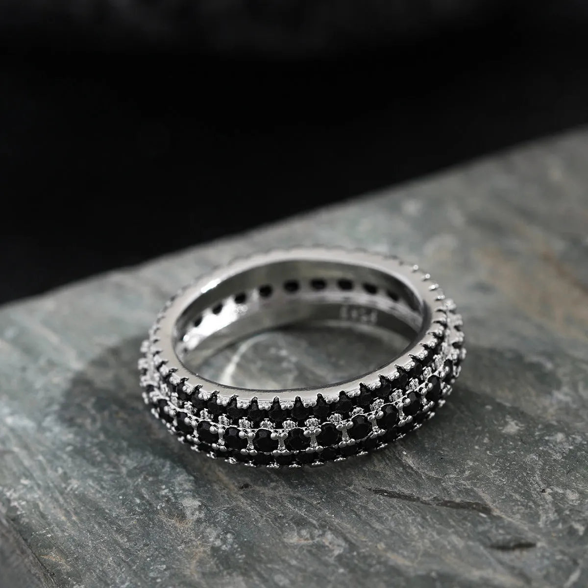 Geometric copper engagement ring with triangular zircon stone inlay, shown in a choice of finishes.