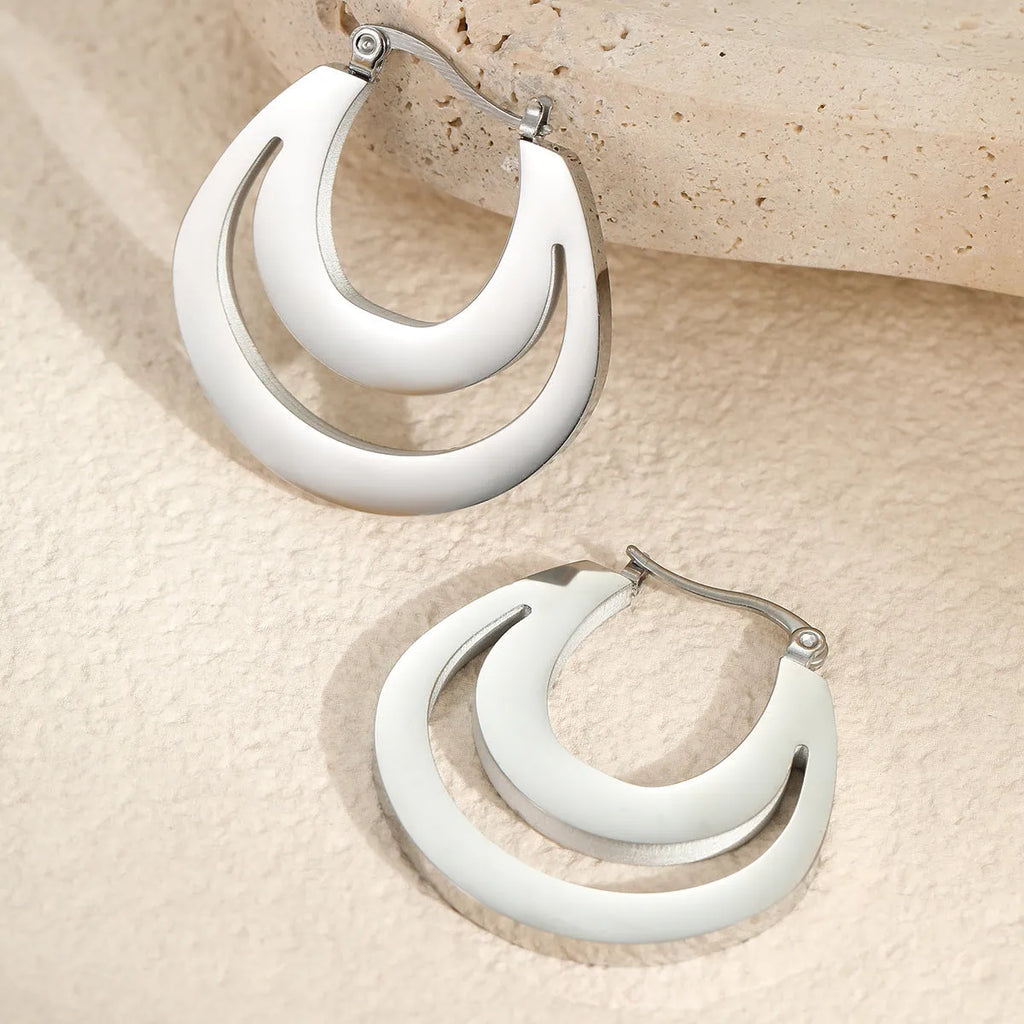 Geometric French earrings with circular ring design in gold and steel metallic finishes
