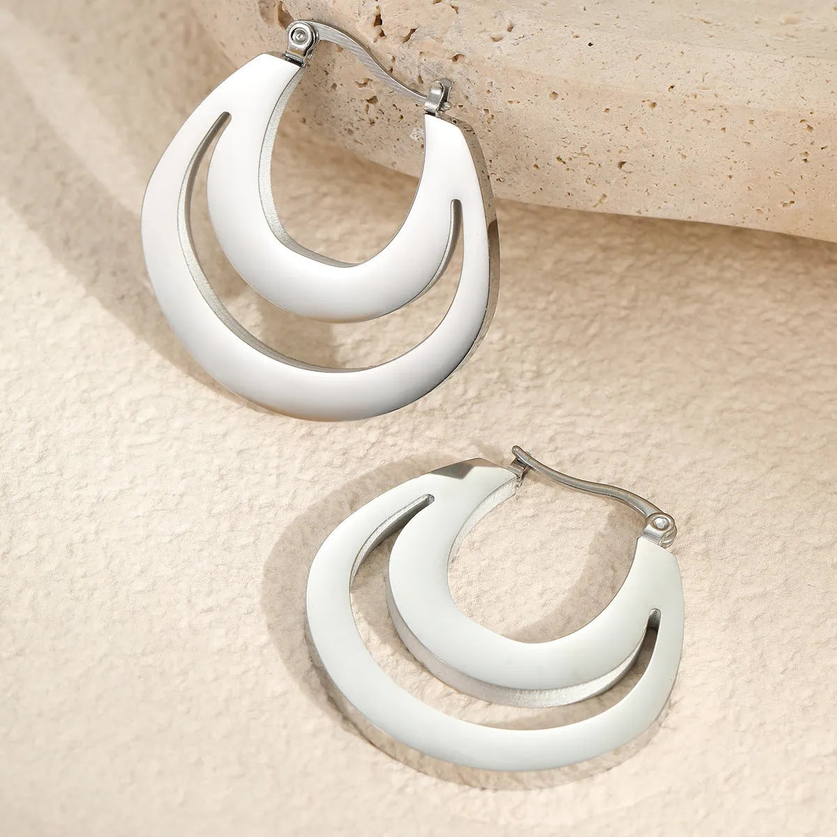 Geometric French earrings with circular ring design in gold and steel metallic finishes