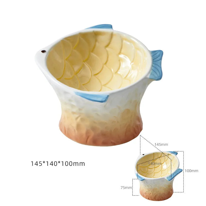 Blue fish-shaped ceramic cat bowl with elevated base and tilted food well