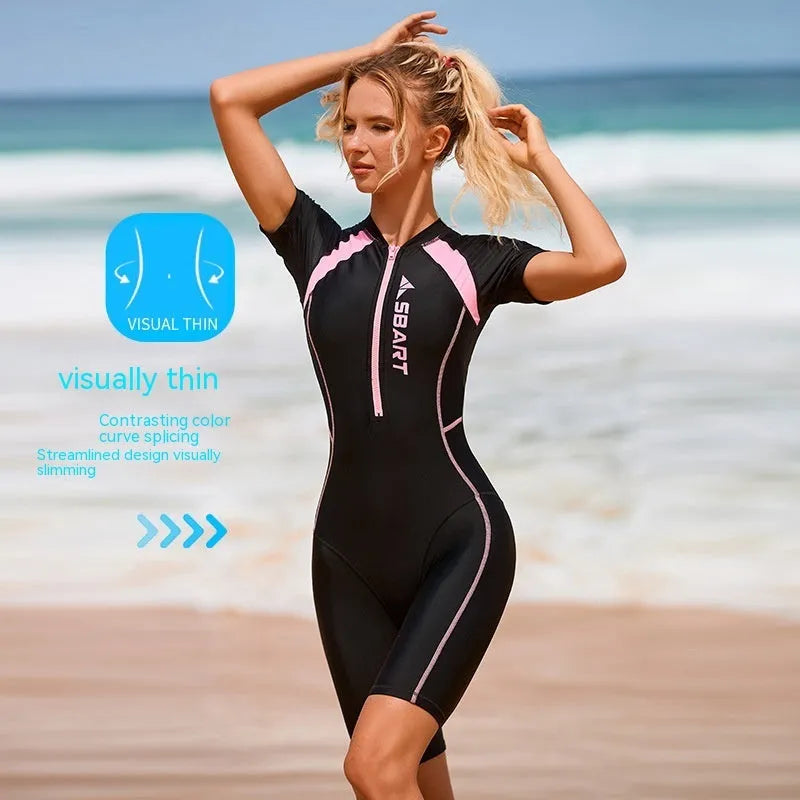 Solid colour women's one-piece surfing swimsuit with short sleeves and a chest pad on a mannequin.