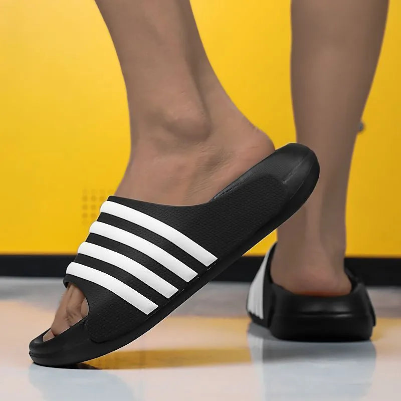 Casual unisex slippers with a light EVA sole and a structured PVC upper, shown in a neutral colour.