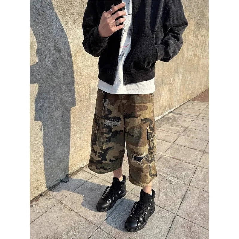 Men's straight-leg cropped jeans in camouflage pattern with patchwork detailing and distressed rips