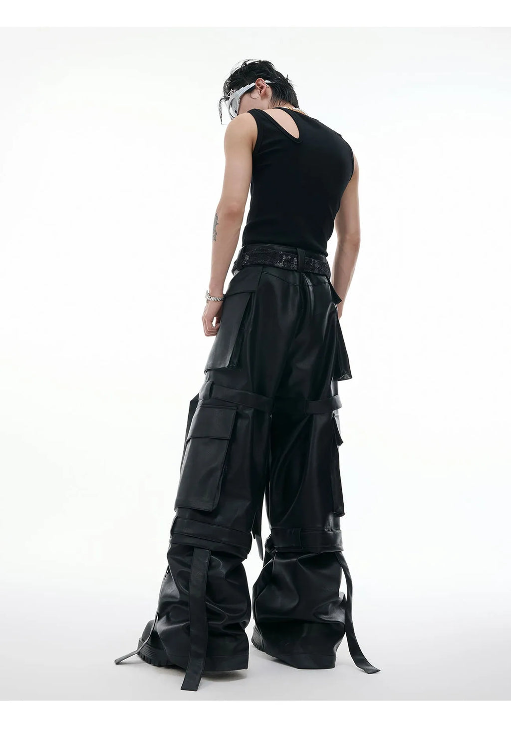 Black loose-fit retro leather pants with quilted panels and multiple pockets.