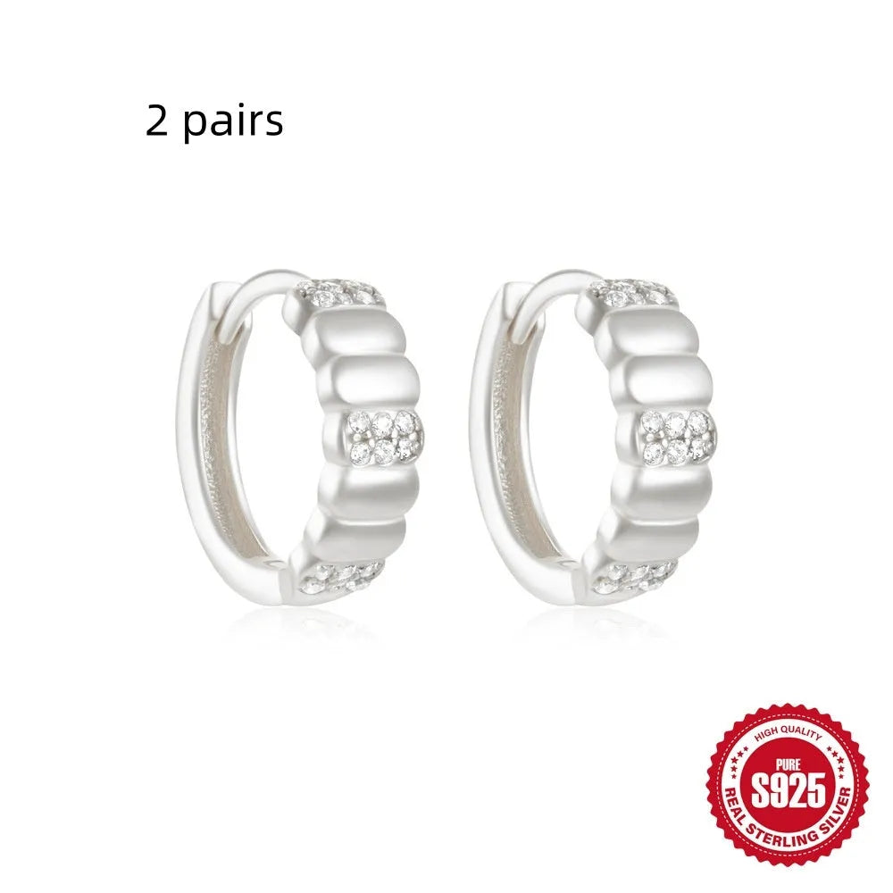 Small round geometric sterling silver stud earrings with diamond-cut detail in gold or silver electroplated finishes