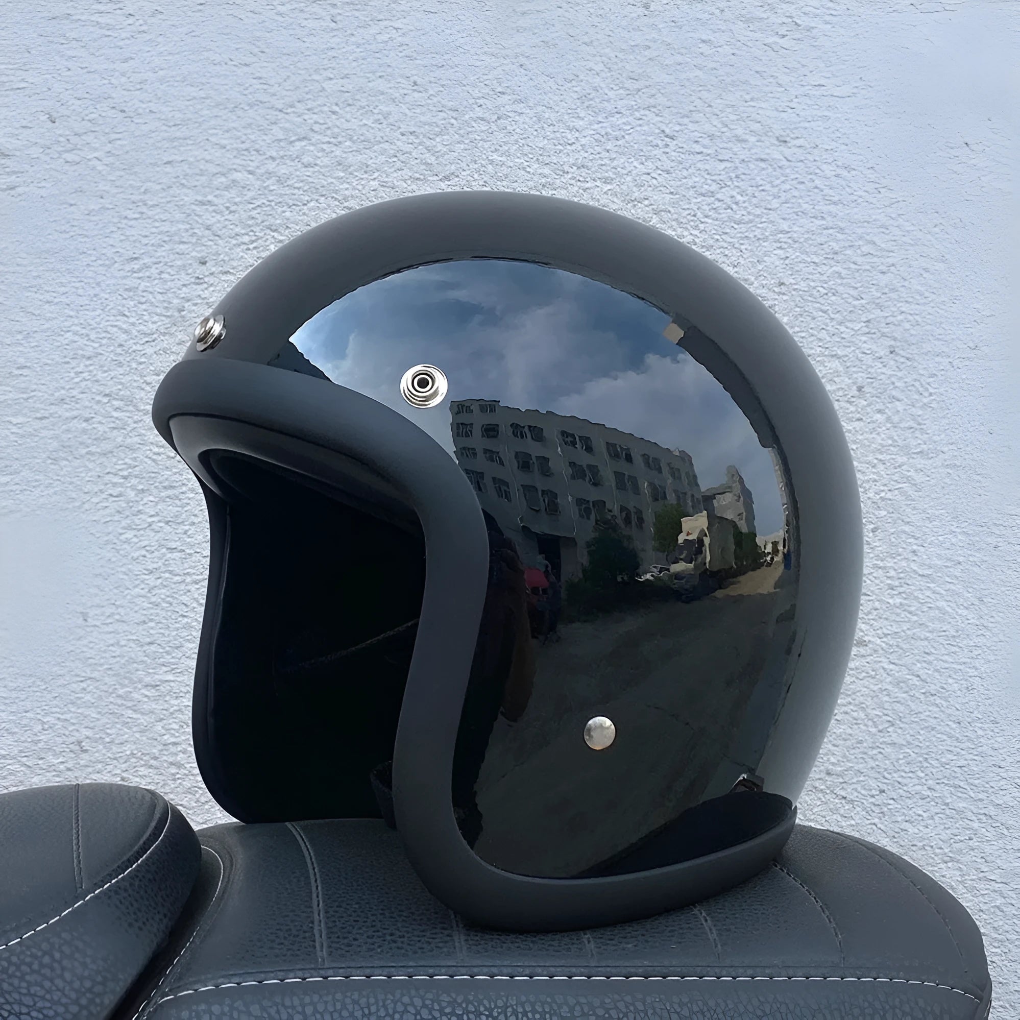 Glass fibre motorcycle half helmet shown in a retro style on a stand.