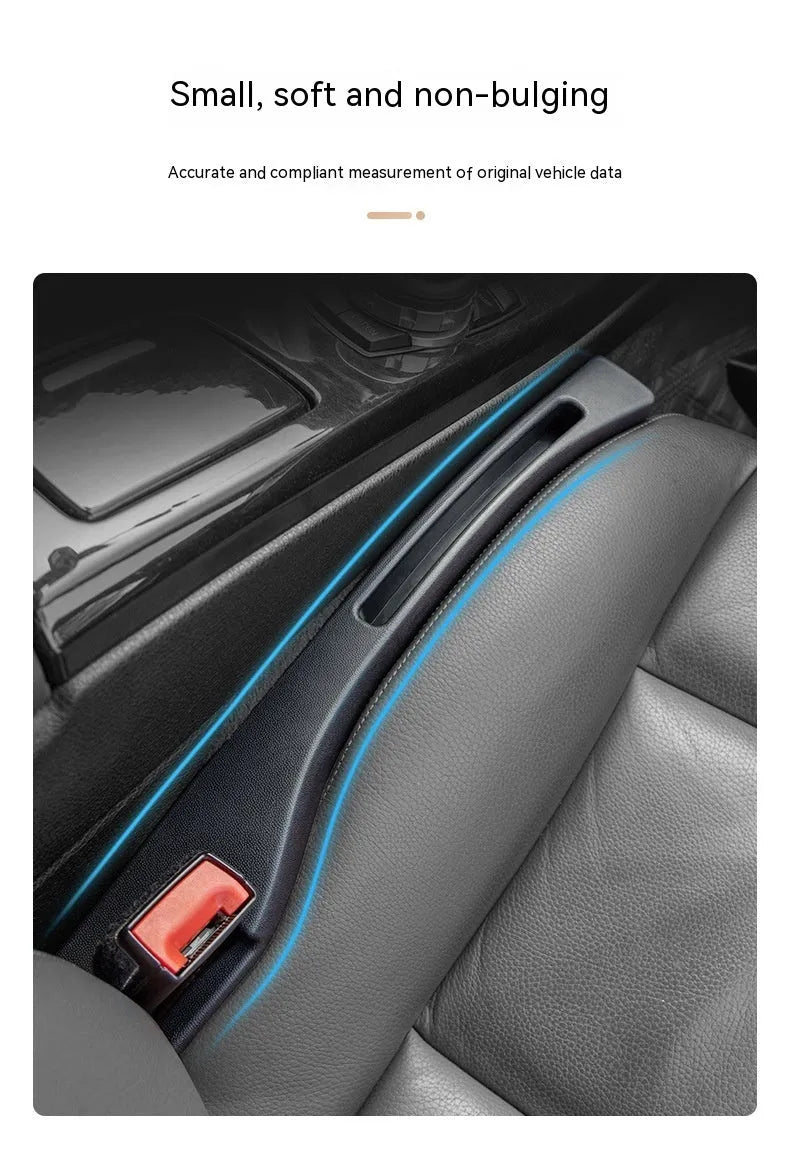 Black plastic car seat gap storage box with removal handle inserted between vehicle seats