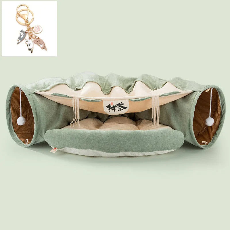 Collapsible cloth cat tunnel folded flat next to a cat, showing Coffee colour option.