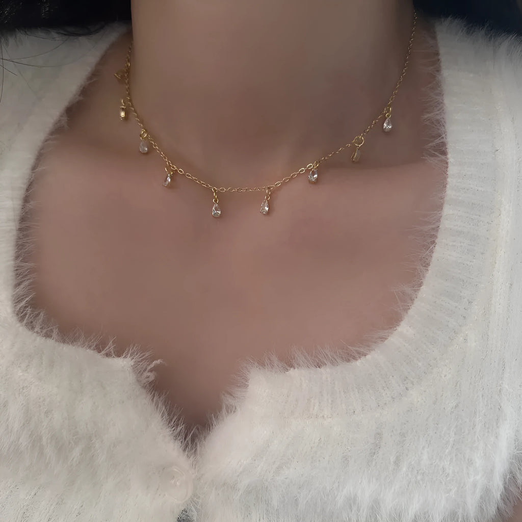 Women's zircon jewellery set showing necklace, earrings and anklet with geometric meteor shower design