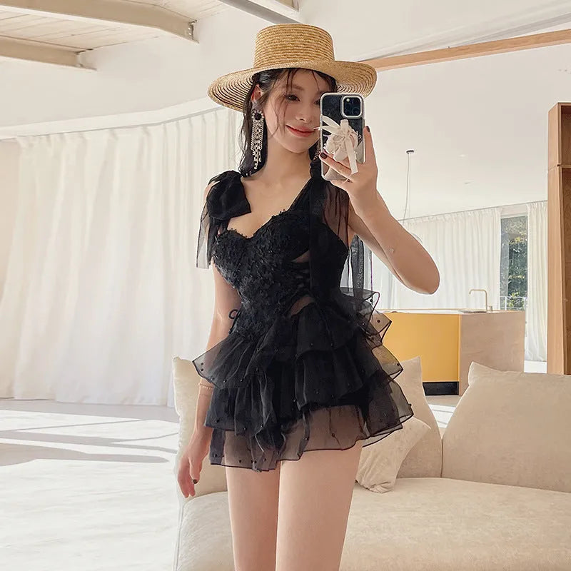 Black conservative one-piece swimsuit with gathered chest design, sleeveless swimwear