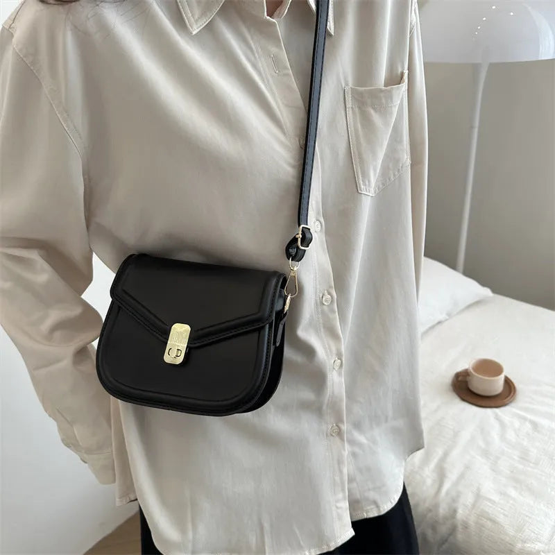 Soft PU messenger bag with textured finish and clamshell opening in horizontal square shape