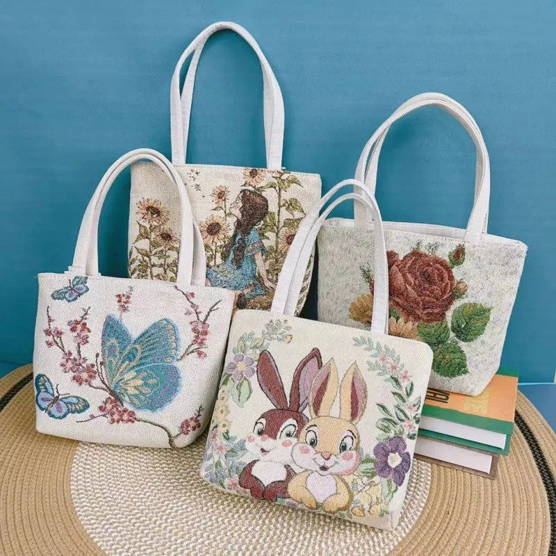 Double-sided gold wire embroidered canvas tote bag showing front and back design, available in multiple sizes and colours.