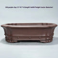 Purple clay handmade rectangular antique flower pot on a desktop.