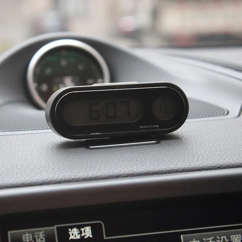 Black car electronic clock thermometer with digital LED display showing time and temperature