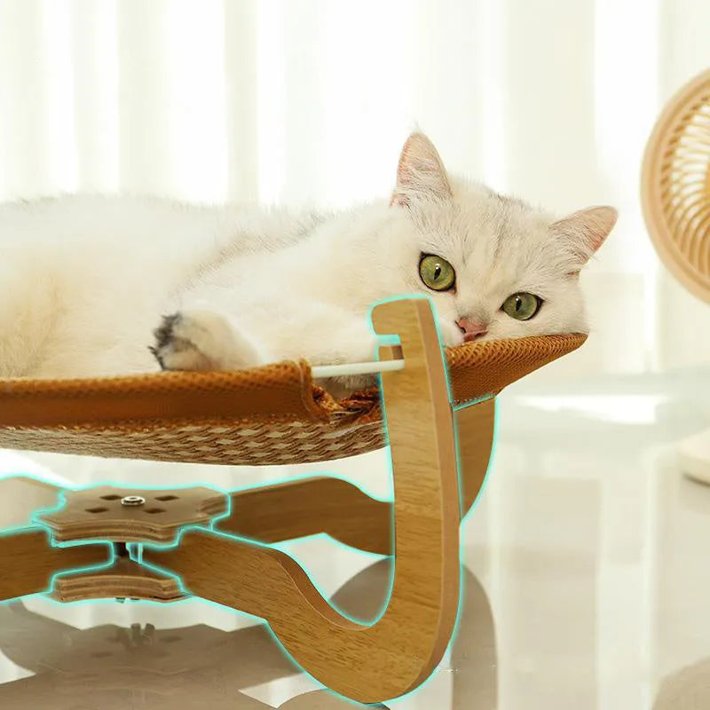 Natural brown woven rattan pet hammock with raised sides on a wooden floor.