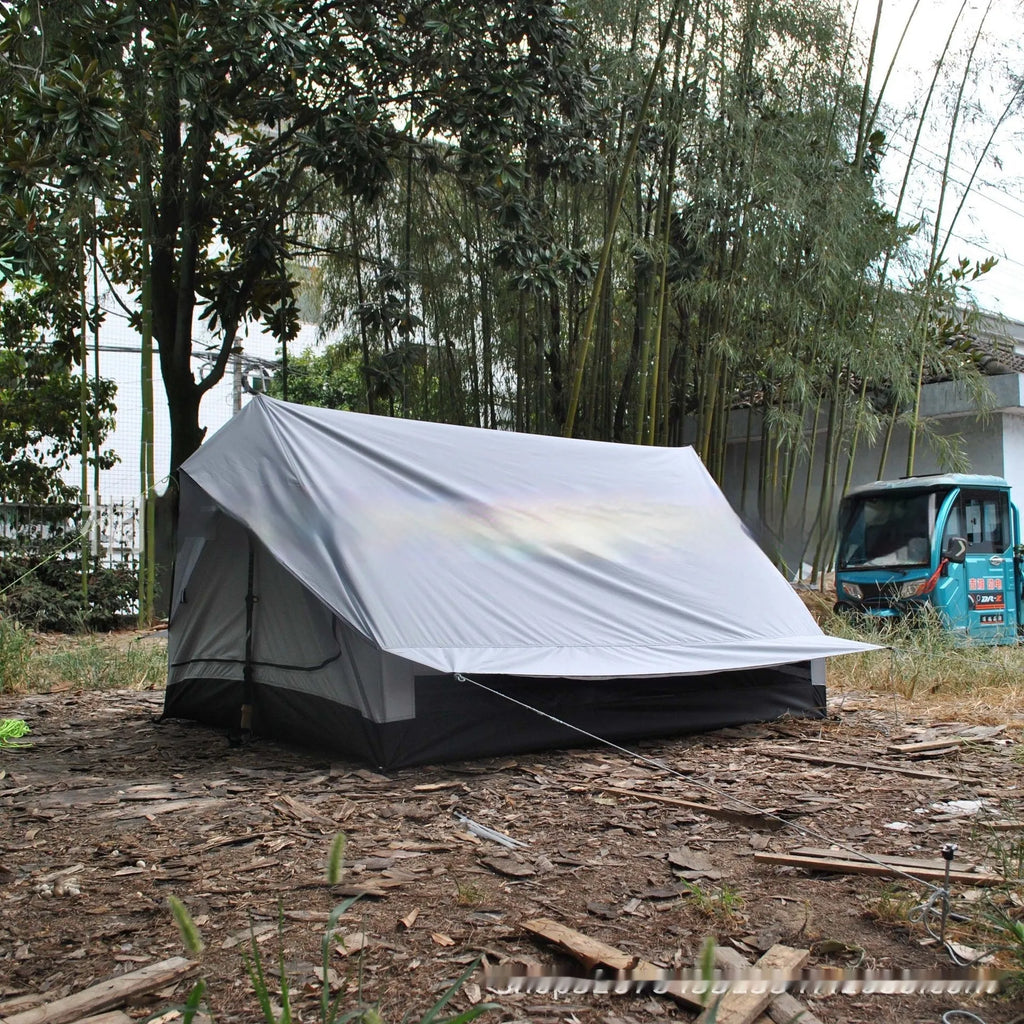Brown A-line cabin tent setup with hiking pole supports showing spacious interior and waterproof fabric construction
