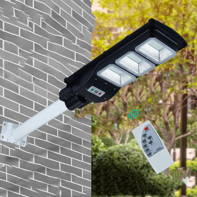 Integrated solar street light with 60W LED panel and remote control for outdoor pathway illumination.