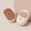 White rechargeable pet steam brush with water tank for grooming dogs and cats.