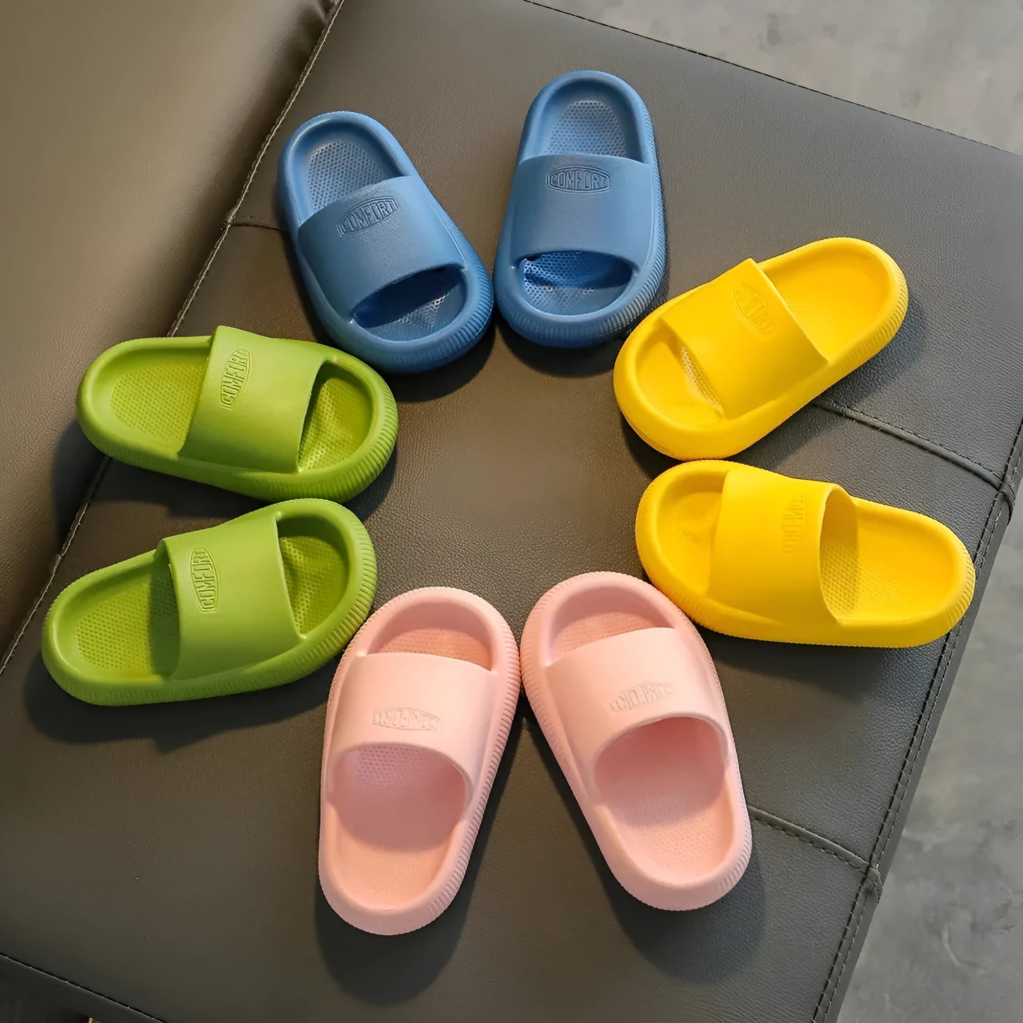 Colourful children's EVA slippers with a thick, textured non-slip sole in various sizes.