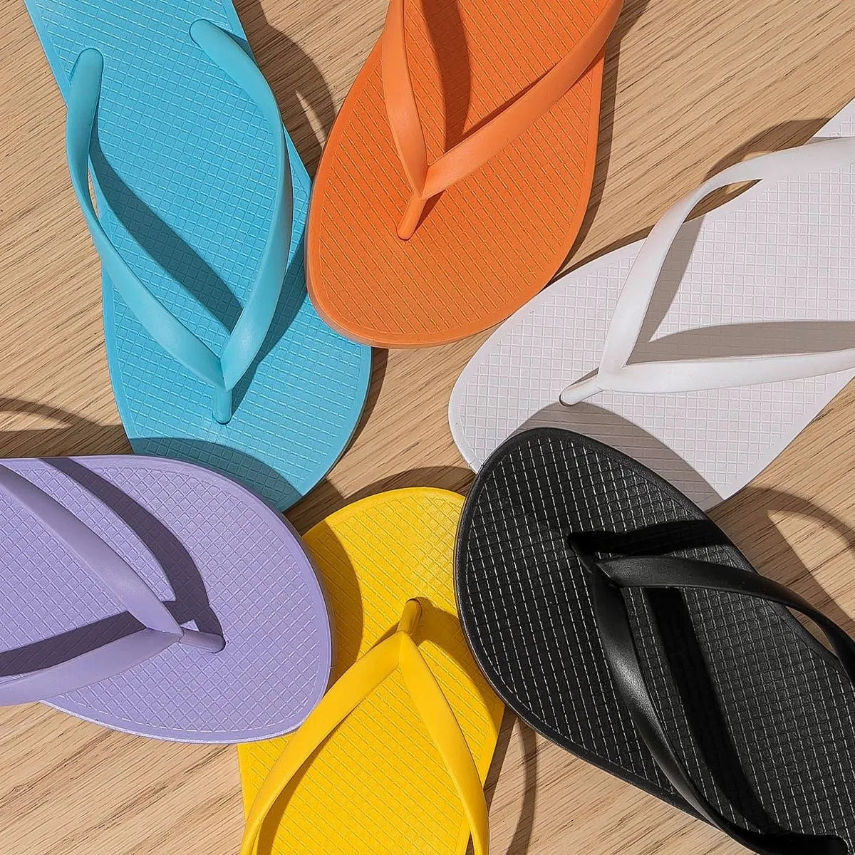Foldable flat casual slippers with hollow-out plastic upper and non-slip PVC sole in assorted colours.