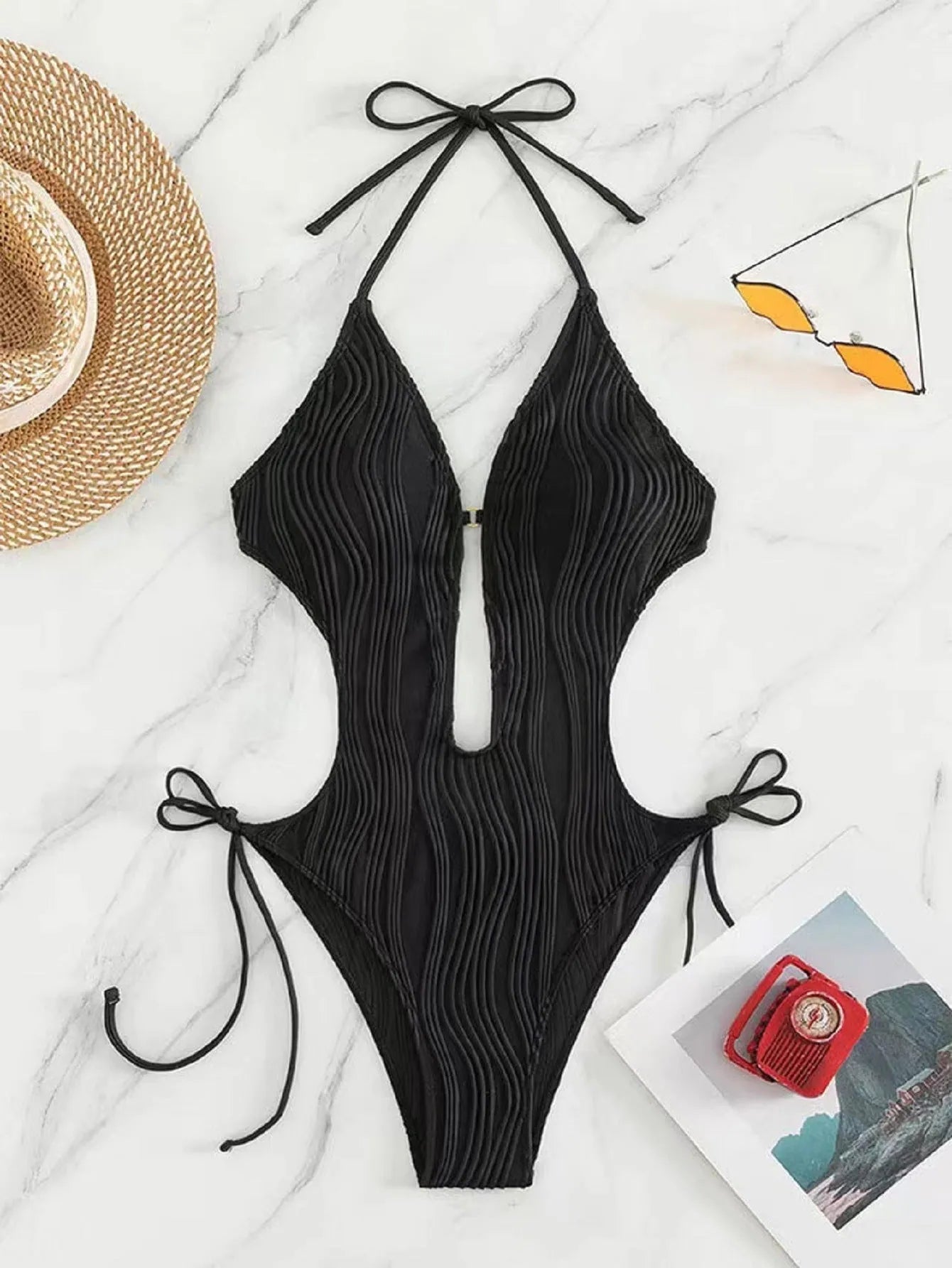 Women's black triangle bikini with white lace-up fastening detail on the front