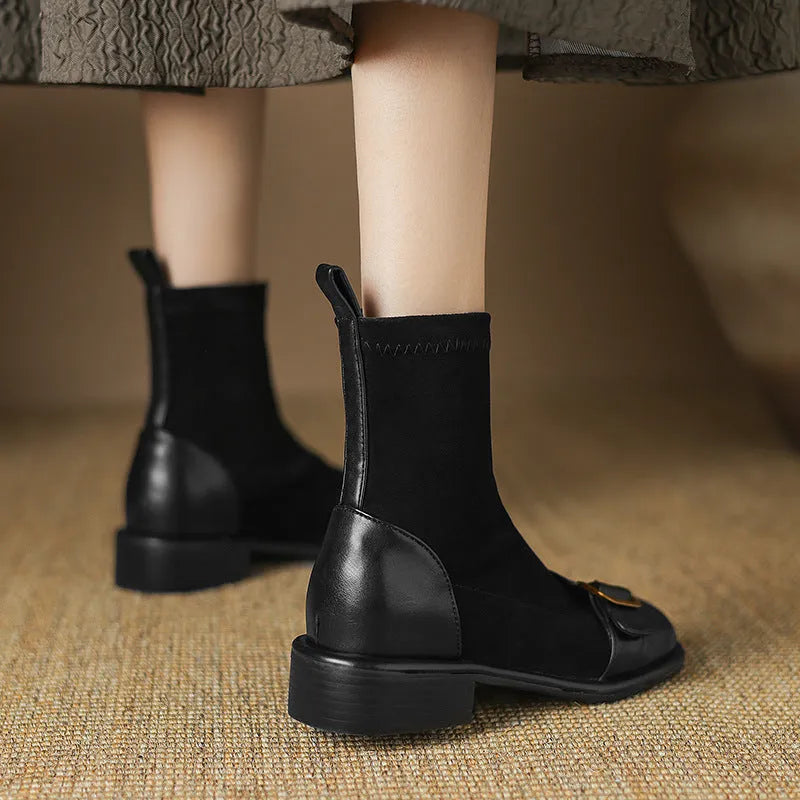 Women's black casual Martin-style ankle boots with buckle stitching and front lace-up on a low rubber sole.