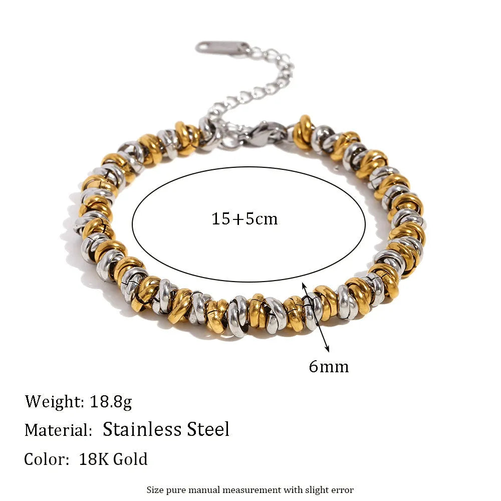 Gold electroplated stainless steel jewellery set comprising geometric earrings, bracelet and necklace.