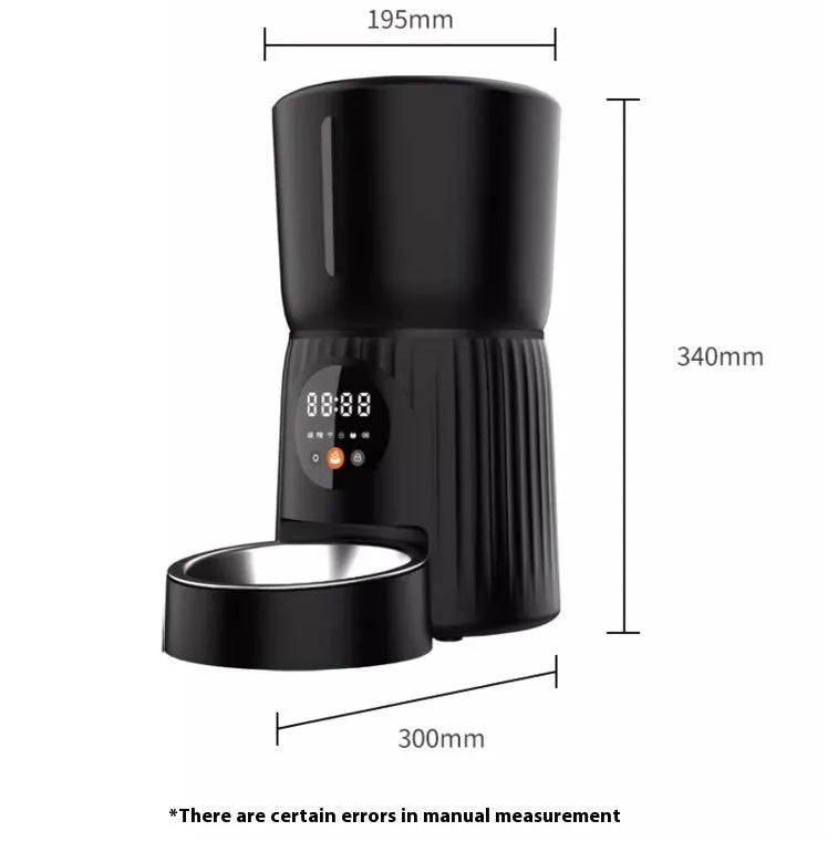 Black automatic pet feeder with digital display and food hopper on a countertop.