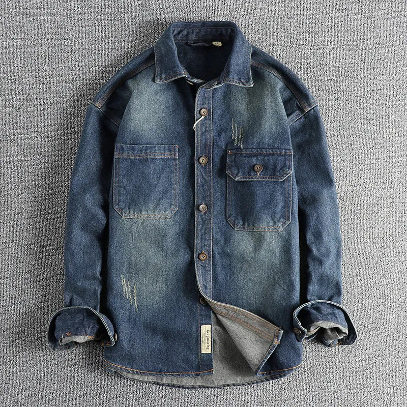 Man wearing a light blue loose-fit vintage denim shirt with long sleeves in a cardigan style.