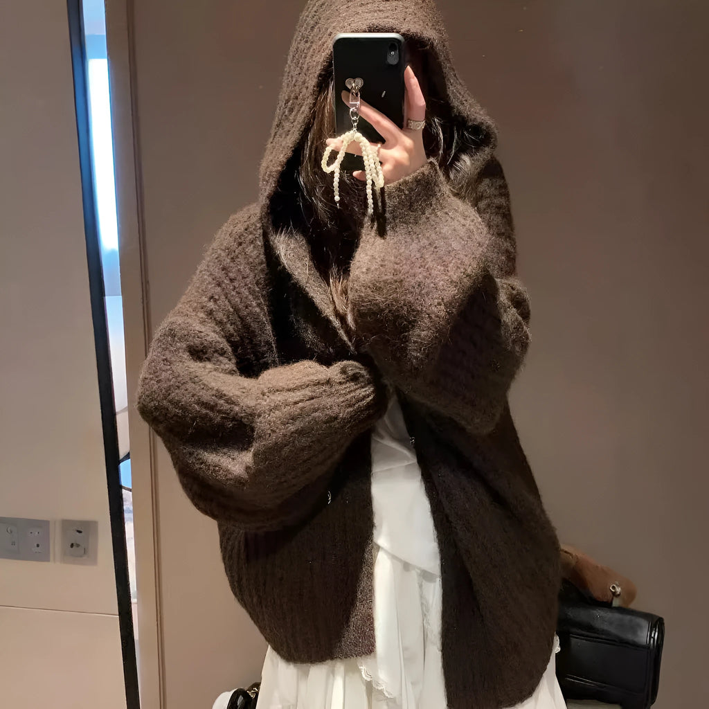Brown women's loose-fit hooded acrylic sweater cardigan with retro style on a hanger.